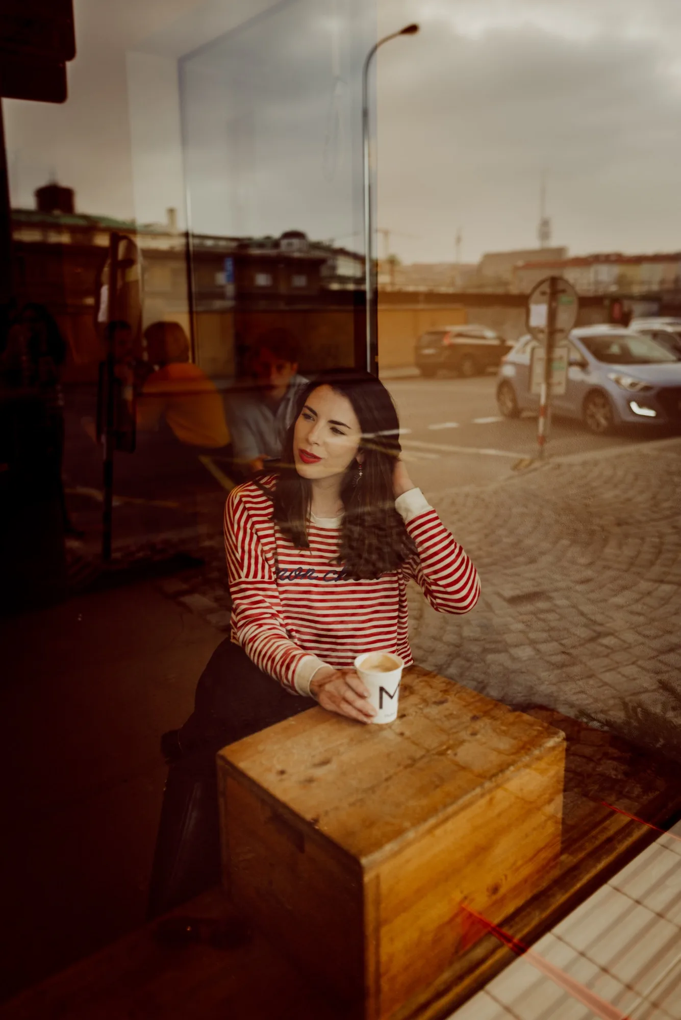 Sarah-Jayne in a red striped top at a cafe in Prague
