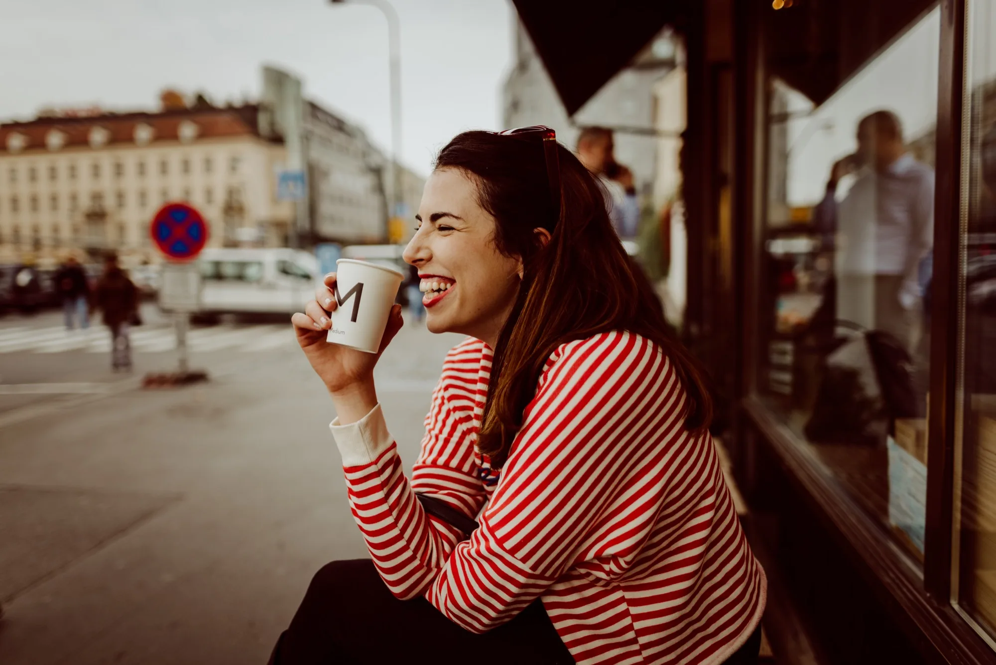 Sarah-Jayne laughing over coffee in Prague